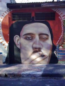 a mural of a man smoking a cigarette